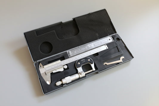 Caliper in a black case on a textured carpet