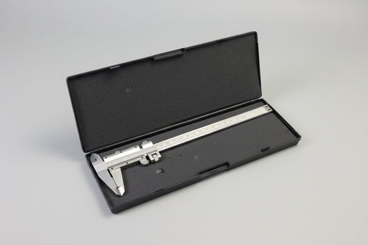 Caliper in a black case on a carpeted floor