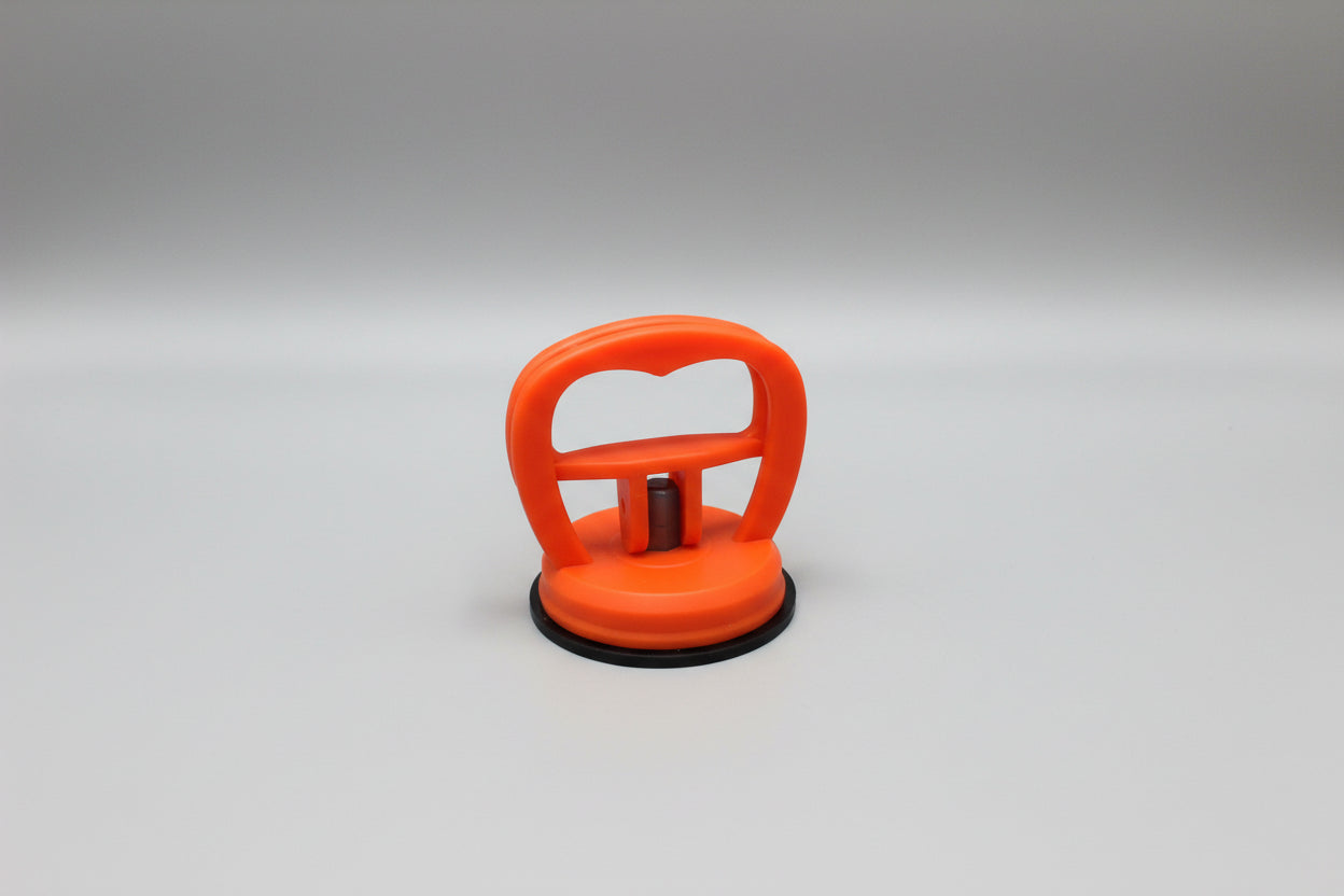 Orange suction cup on a wooden surface